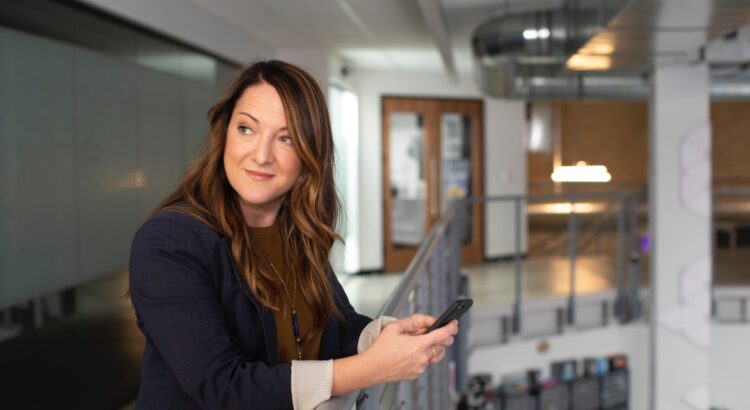 a business woman with a mobile phone in an office